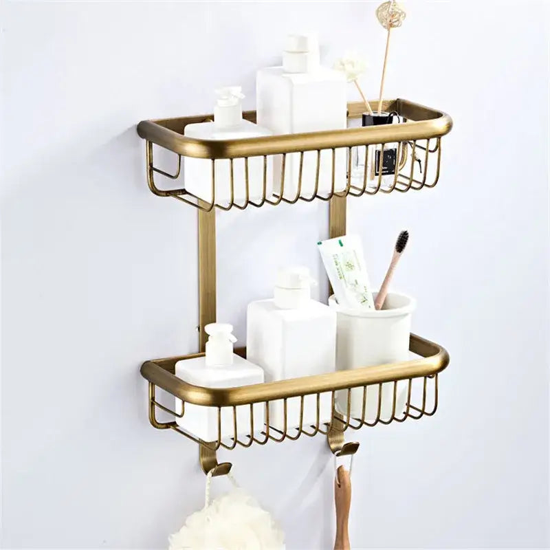 Gold-toned double-tier bathroom shelf with wire mesh baskets and hooks in decorbites bronze bathroom hardware set
