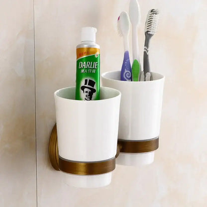 White ceramic toothbrush holder with bronze-colored metallic band from decorbites bronze bathroom hardware set