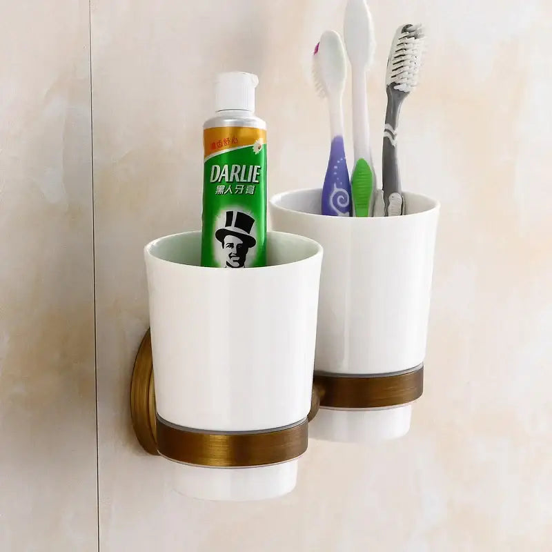 White ceramic toothbrush holder with bronze-colored metallic band from decorbites bronze bathroom hardware set