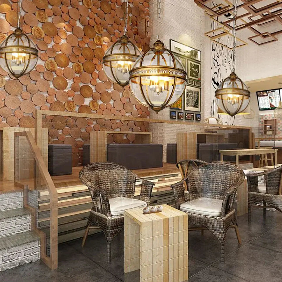 Woven wicker chairs with light gray cushions beneath a decorbites bronze black glass globe chandelier foyer light