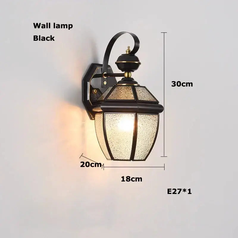 Black wrought iron wall lamp with textured glass panels and curved arm in decorbites bronze black glass globe style