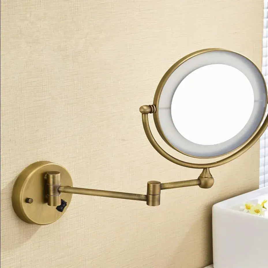 Bronze brass wall mounted led makeup mirror with brass finish, adjustable arm, and circular led-lit magnifying glass by decorbites