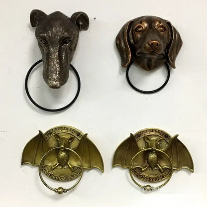 Bronze dog head door and bat door knocker pendant with black rings for courtyard wall installation