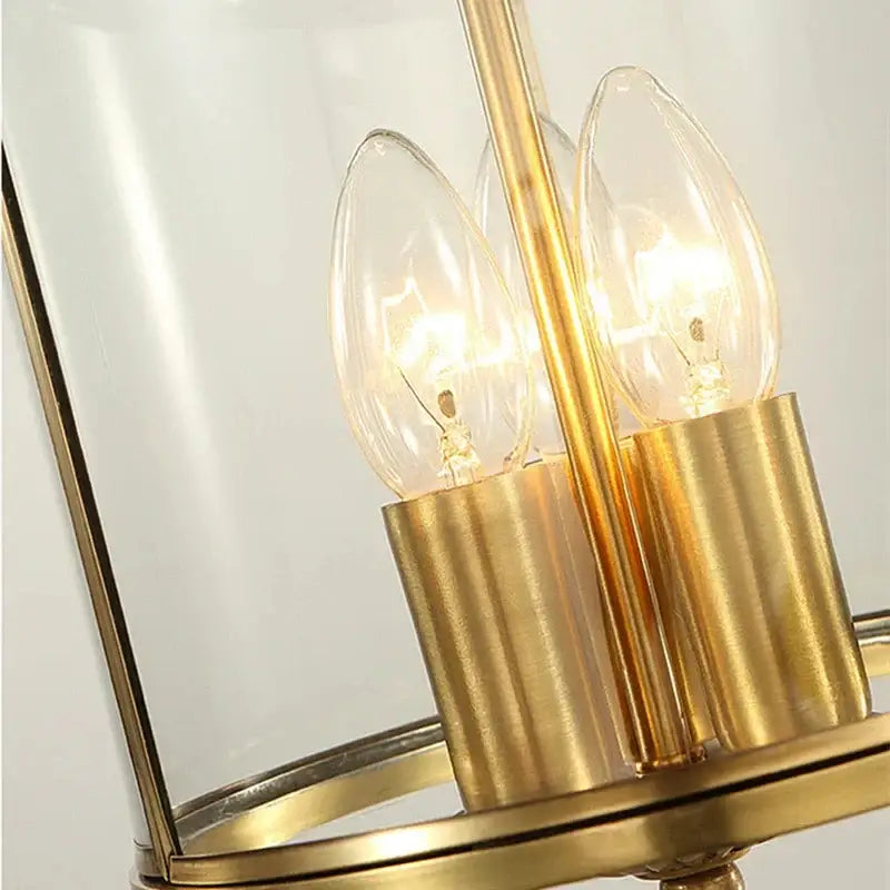 Bronze glass chandelier pendant light with gold-toned metal frame and three illuminated filament bulbs for dining room decorbites bronze glass