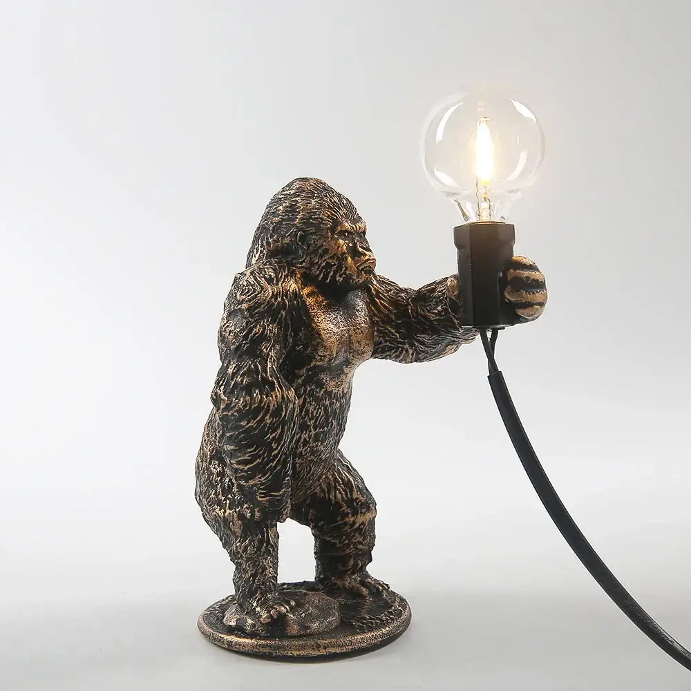 Bronze king kong gorilla table lamp with bronze finish holding a clear bulb for bedroom night light use