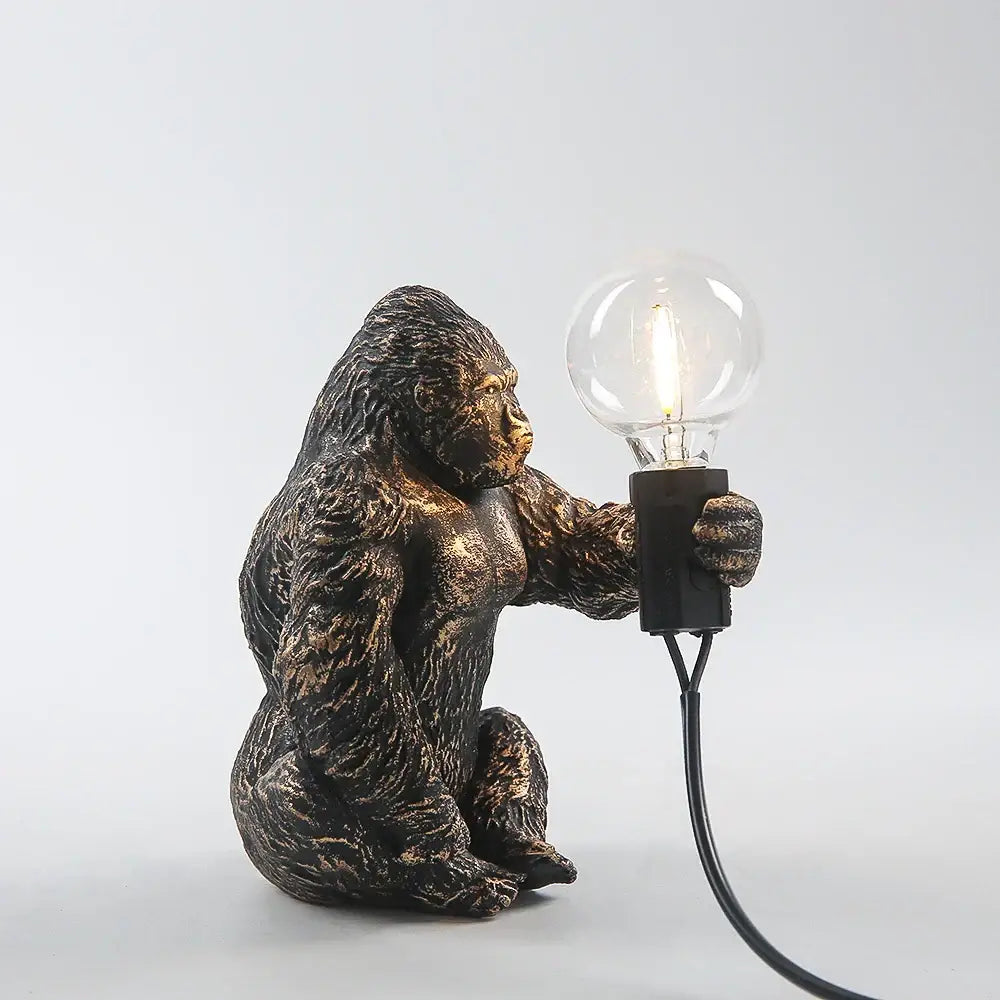 Bronze king kong gorilla table lamp with clear filament bulb as a bedside night light and decorative piece