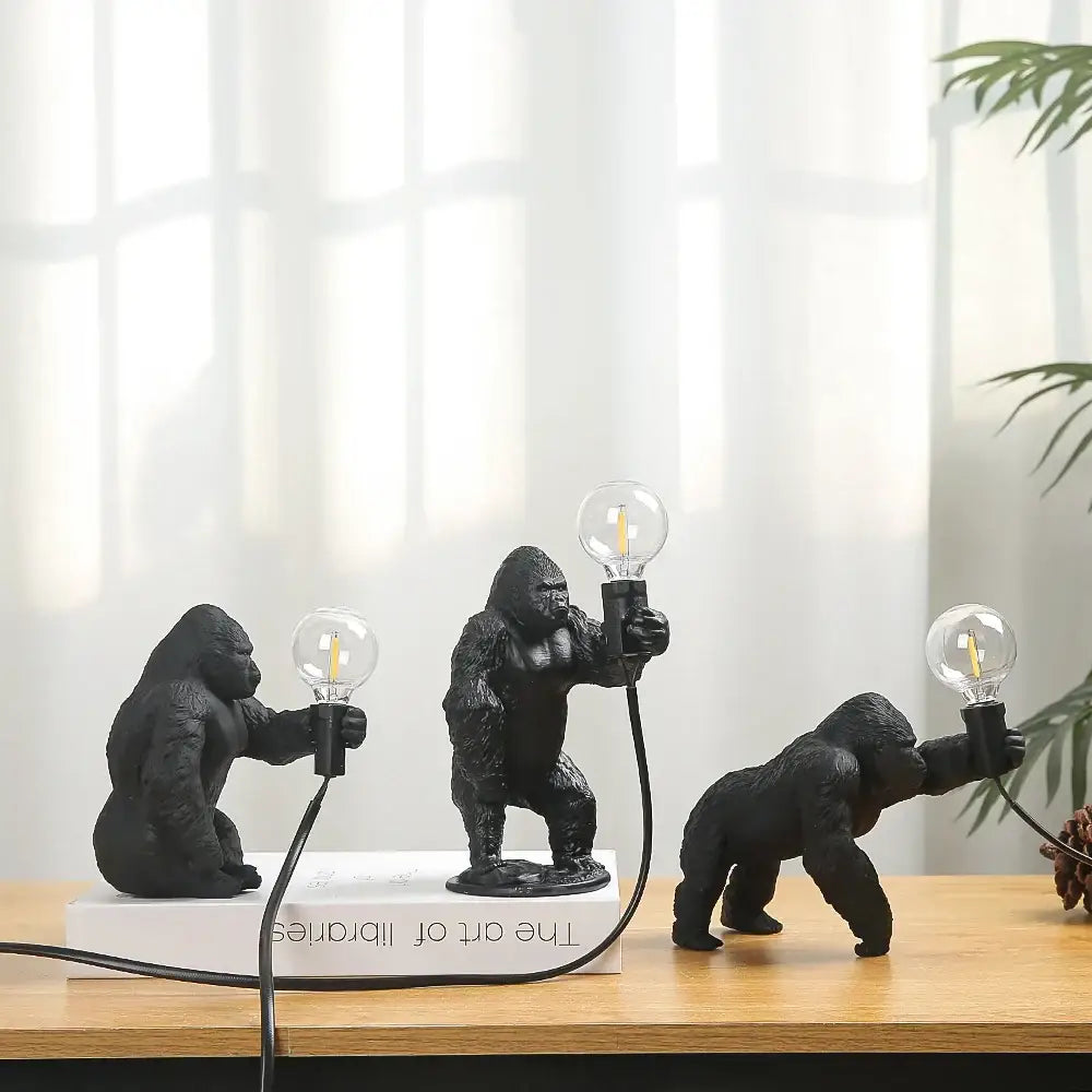 Bronze king kong gorilla table lamp featuring three black figurines holding clear glass bulbs connected by cords for bedroom night light decorbites king kong