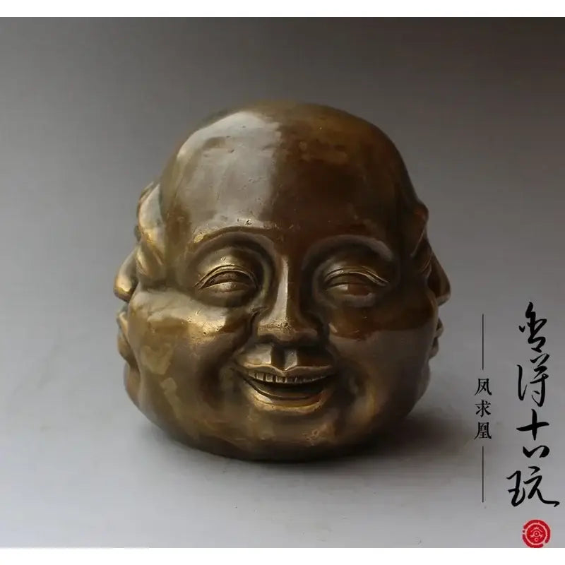 Bronze polished buddha head statue with smooth surface and serene smiling expression for living room decor