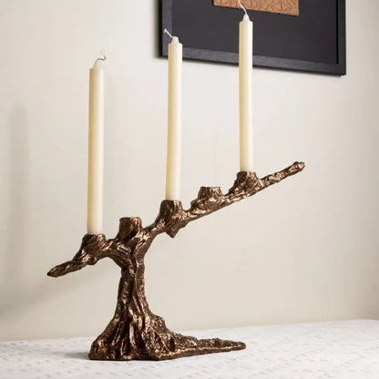 Bronze tree branch bamboo candle holder with three cream candles featuring intricate textured decorbites bamboo candle decor