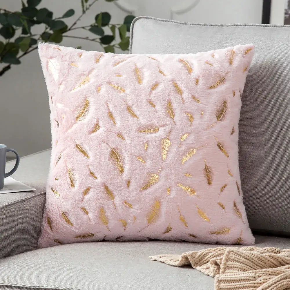 Pink plush throw pillow with bronzed feather style gold embroidery for elegant living room decor