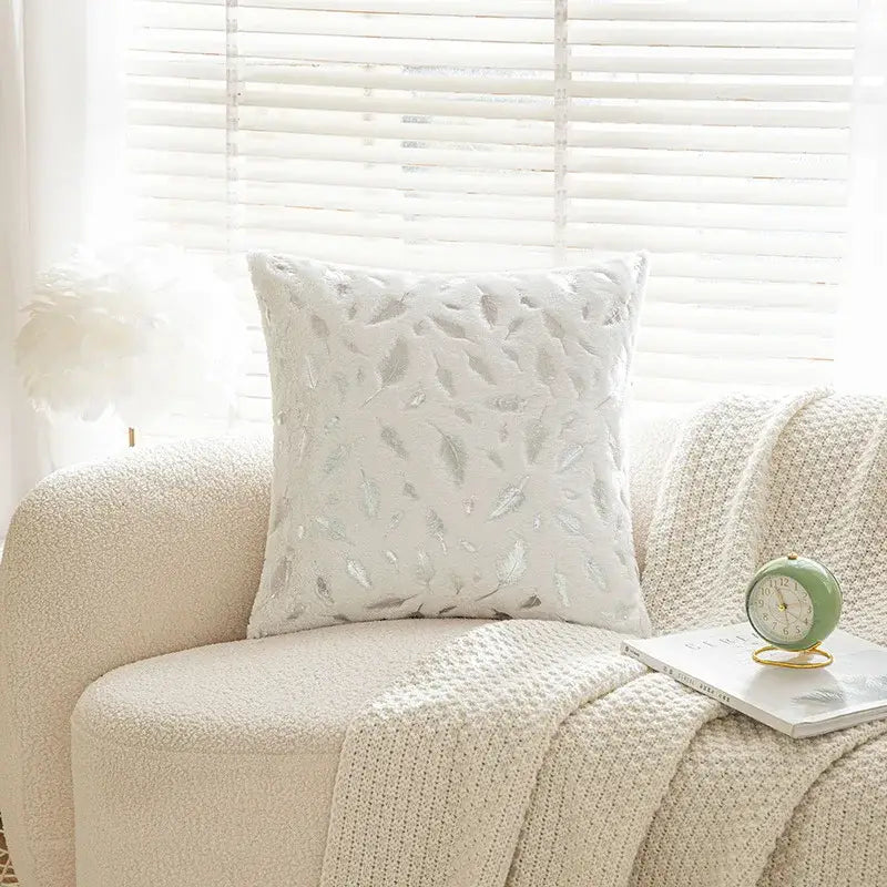 White cushion with silver feather embroidery featuring bronzed feather style for elegant living room decor