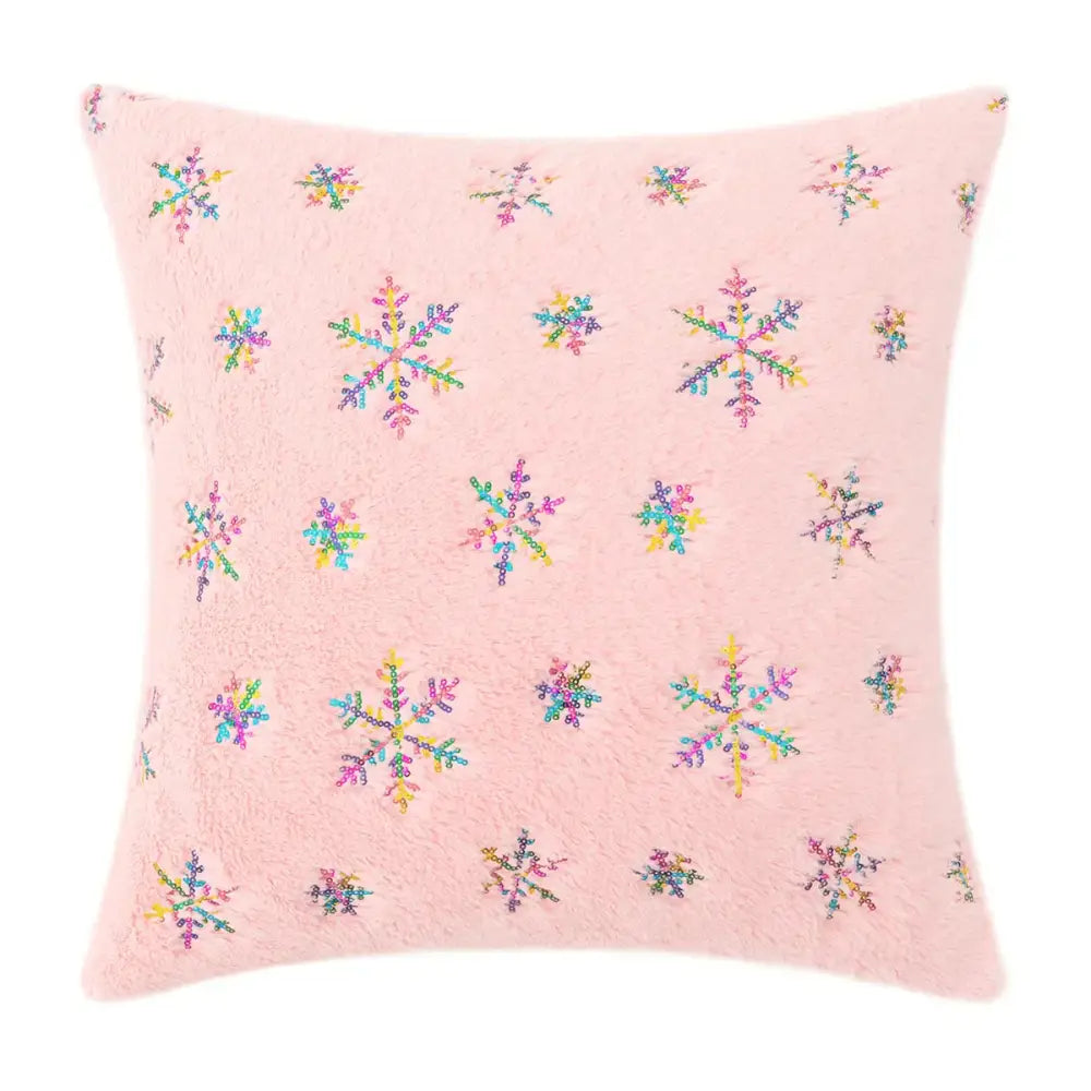 Pink fuzzy pillow with colorful sequined snowflakes featuring bronzed feather style accents for living room decor