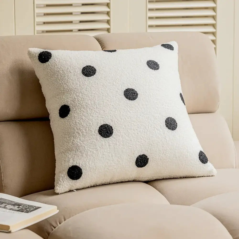Cream-colored plush cushion cover with black polka dots and geometric embroidery for living room decor