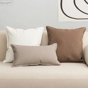 Three textured brown beige faux leather cushion covers 45x45cm on a light sofa for decorbites living room decor