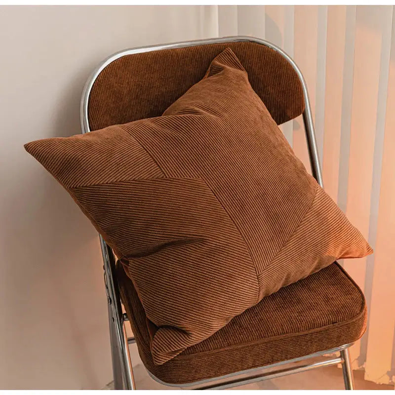 A cozy brown corduroy patchwork cushion cover on a matching chair perfect for living room decorbites brown corduroy decor