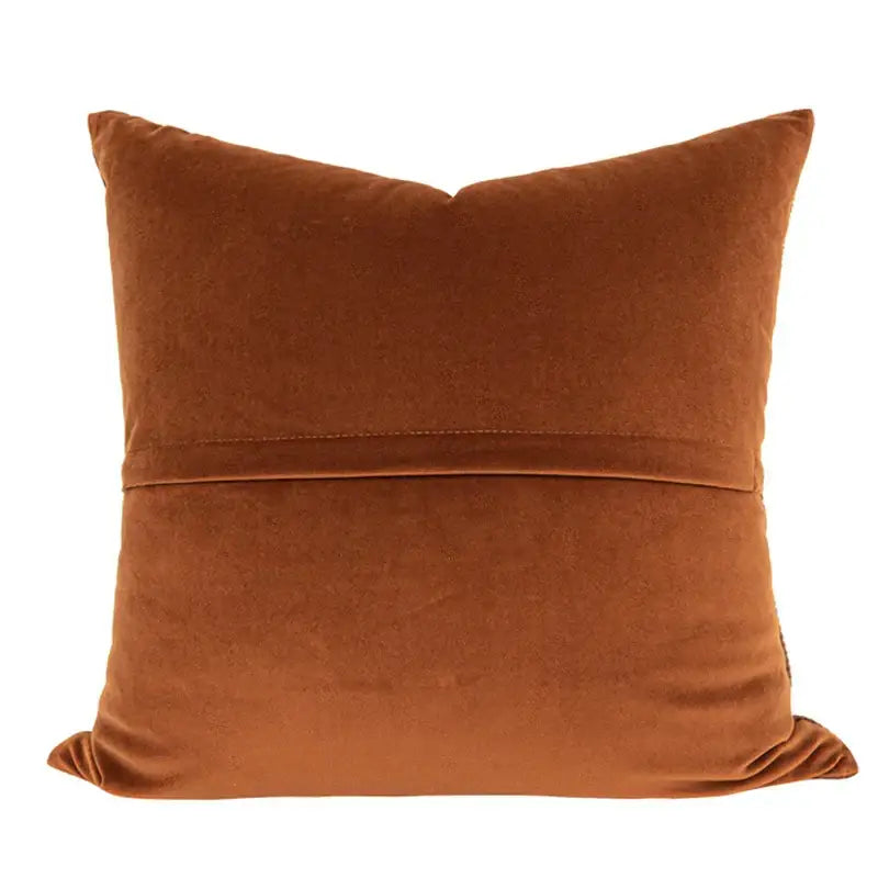 Brown corduroy patchwork cushion cover featuring a square rust-colored velvet pillow with a subtle horizontal seam