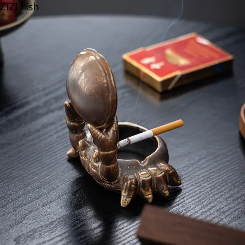 Brown bronze-colored crab ceramic ashtray with glossy finish holding egg bowl and detailed claws as phone holder decorbites crab ceramic