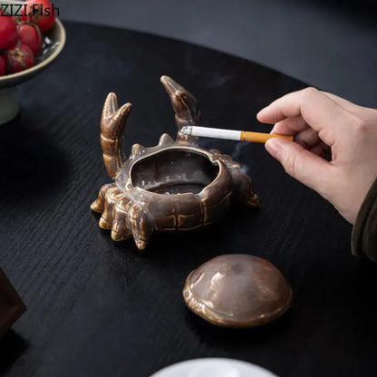 Bronze-colored decorbites crab ceramic ashtray with detailed claws and shell texture serves as phone holder and desk decoration