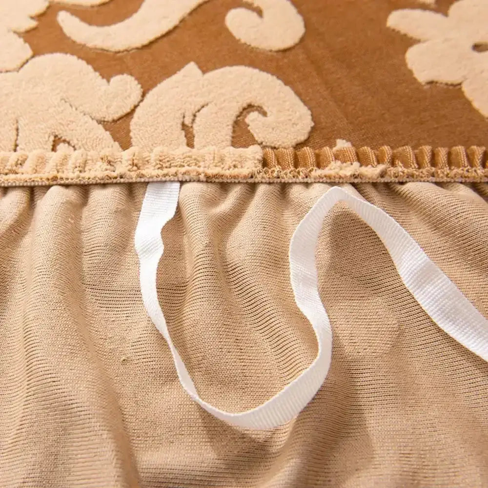 Beige embroidered bedspread with floral patterns and ruffled edge featuring white elastic ties for decorbites 3d solid embossed sofa cover slipcovers