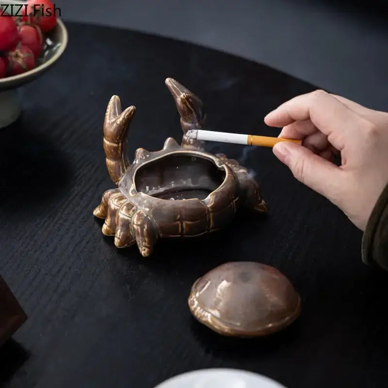 Bronze-colored decorbites crab ceramic ashtray and phone holder with detailed claws and shell design for office decor