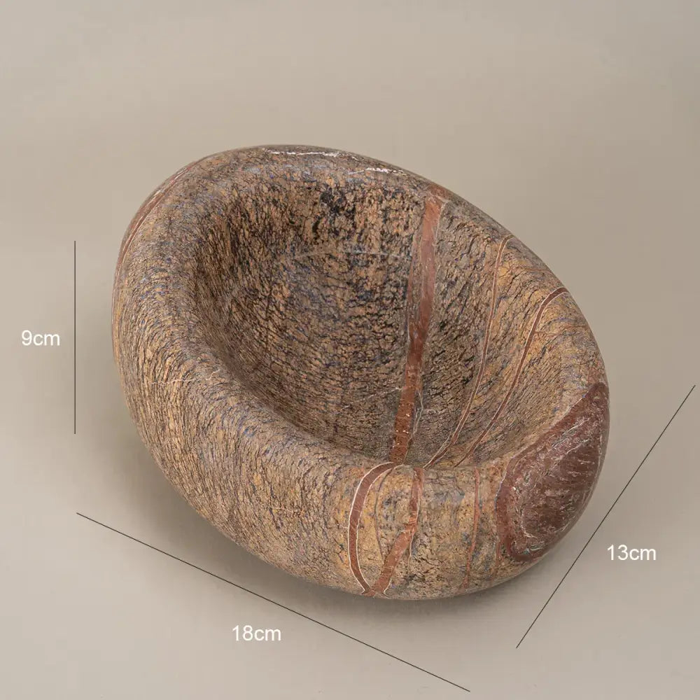 Hand-carved brown and gray nest marble bowl with natural earthy texture and reddish veining for bedroom jewelry storage