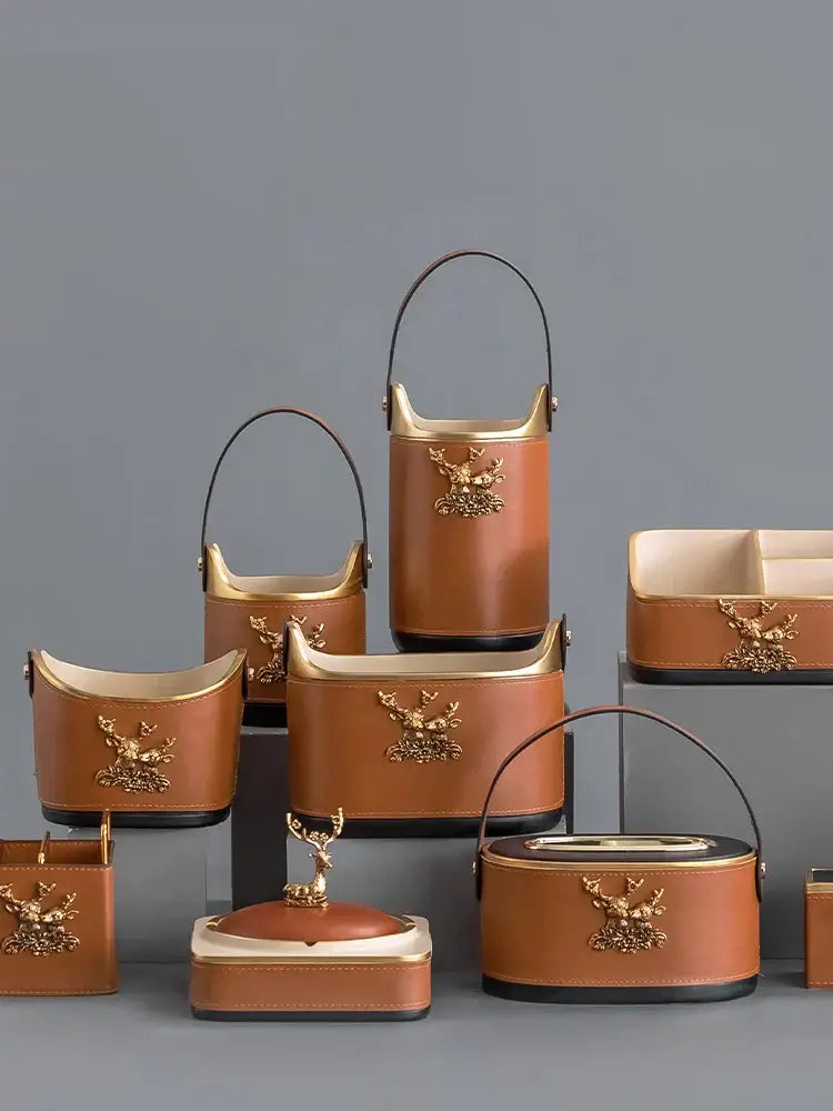 Brown leather desktop storage basket with gold deer embellishments and black handles for office organization
