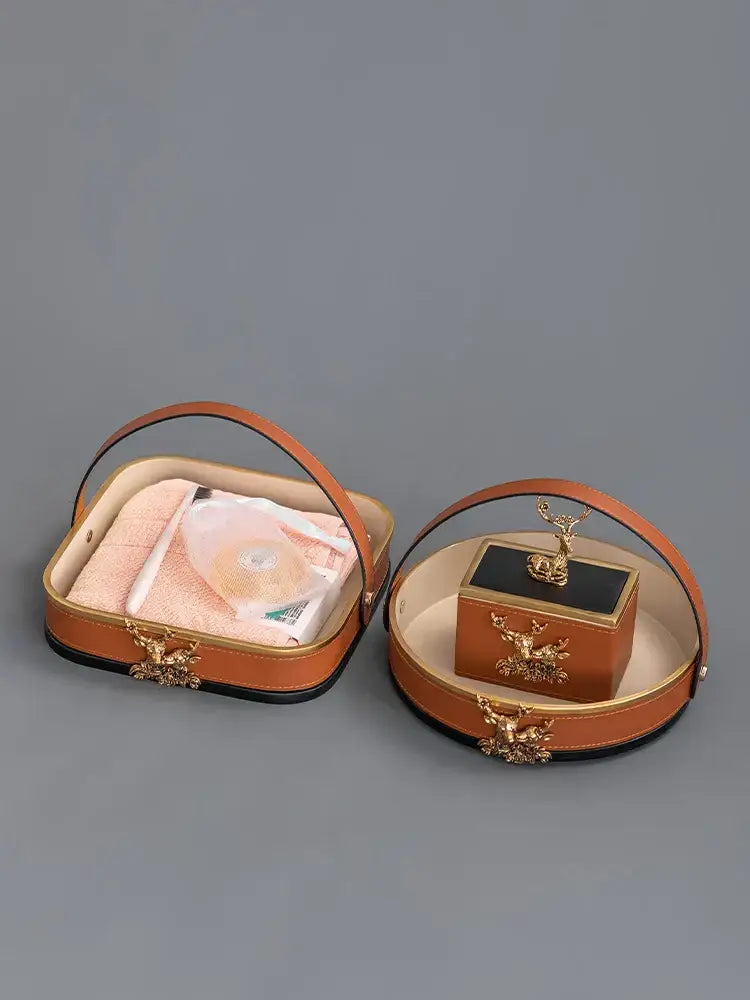 Brown leather desktop storage basket with gold-toned deer embellishments and matching handle for office use