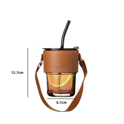 Brown leather glass coffee cup with adjustable strap and black straw wrapped in leather for stylish coffee cup use