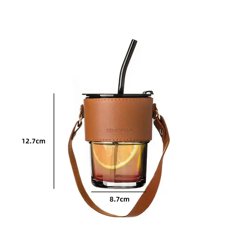 Brown leather glass coffee cup with adjustable strap and black straw wrapped in leather for stylish coffee cup use