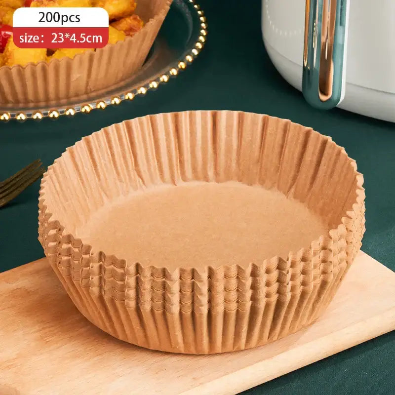Brown non-stick barbecue paper baking cups with fluted edges stacked on wooden board for kitchen cooking use