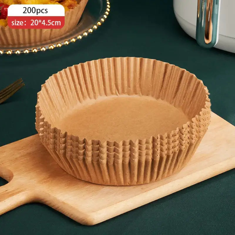 A stack of brown non-stick barbecue paper baking cups on a wooden cutting board for kitchen cooking use