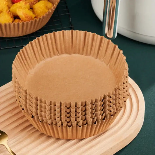 Stack of brown non-stick barbecue paper baking cups with fluted edges for kitchen cooking and barbecue use