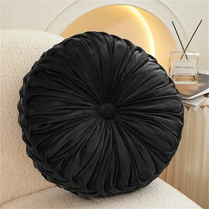 Black velvet round seat cushion with gathered pleated design and central button for living room use