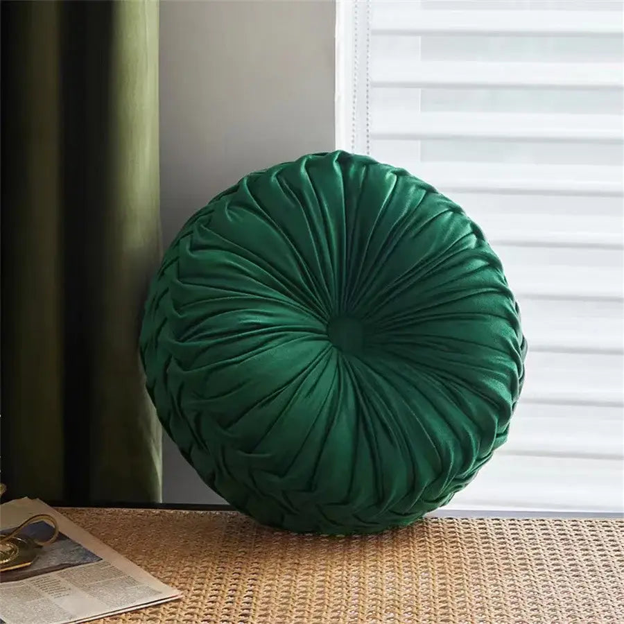 Deep emerald green velvet round seat cushion with gathered radial pleated design for living room use