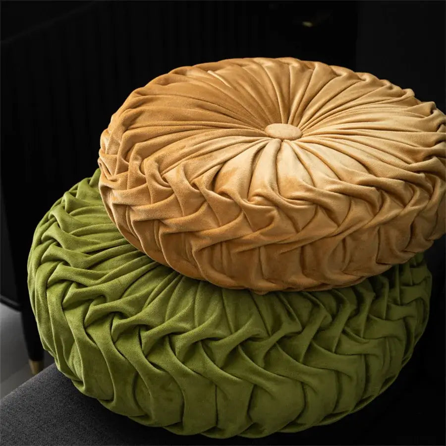 A plush brown pleated dutch velvet round seat cushion with intricate details stacked on a matching green velvet round seat cushion