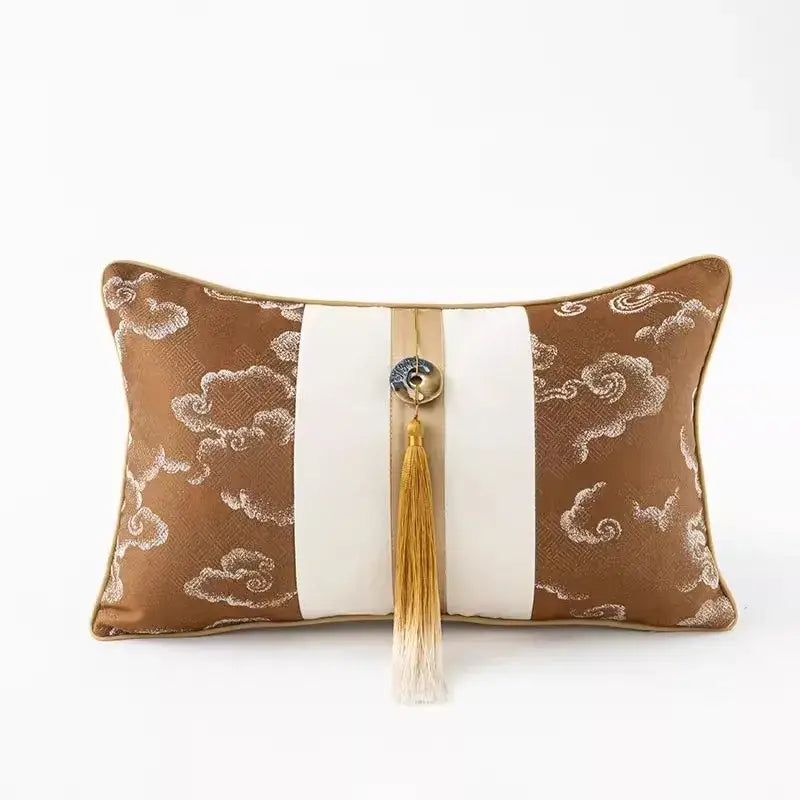 Brown and cream embroidered clouds jacquard throw pillow cover with central white stripe and gold-tasselled button detail
