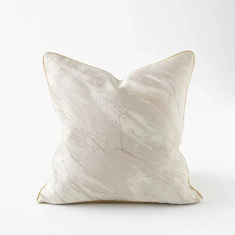 Cream-colored pillow cover with subtle marble texture and gold piping featuring auspicious clouds jacquard design