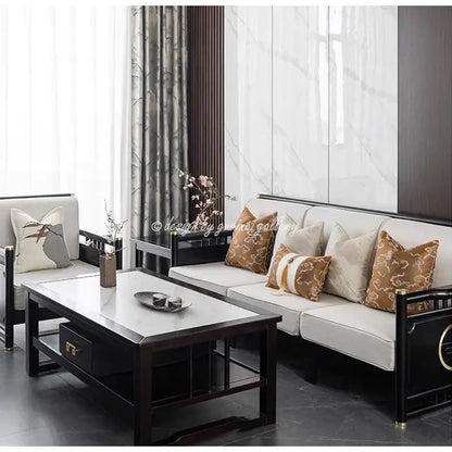 Black-framed sofa with white upholstery and brown and white auspicious clouds jacquard pillow cover throw pillows