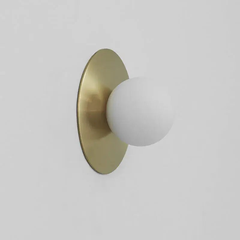 Minimalist brushed brass circular wall lamp with matte white frosted glass shade for bedroom decorbites circular wall use