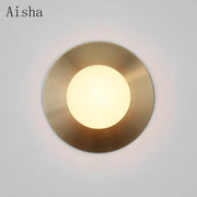 Aisha brand brushed brass circular wall lamp with frosted glass panel providing warm diffused glow for decorbites circular wall lighting