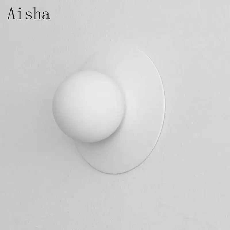 White spherical wall lamp with a smooth matte finish and minimalist design for bedroom decorbites circular wall lamp