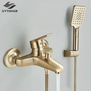 Brass-finished shower faucet mixer set with integrated showerhead and flexible hose in brushed gold and black finish