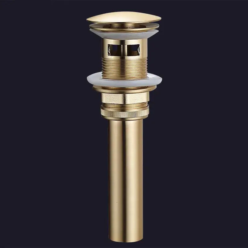 Brushed gold and white ceramic bathroom sink drain assembly kit with sleek cylindrical brass drain and integrated stopper