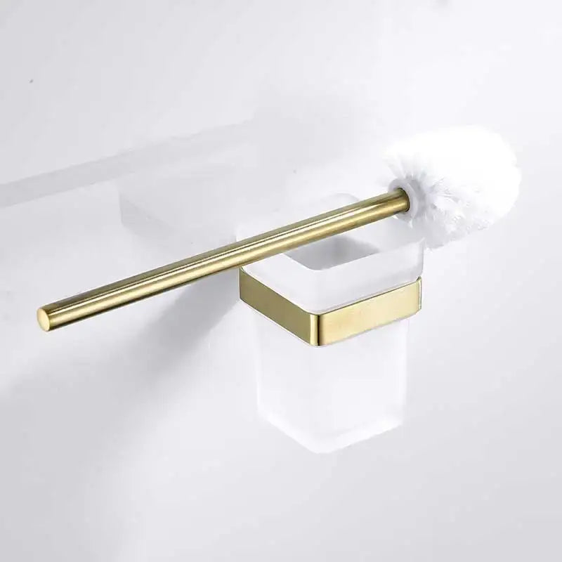 Brushed gold stainless steel toilet brush with white bristle head in a translucent glass holder from decorbites brushed gold set