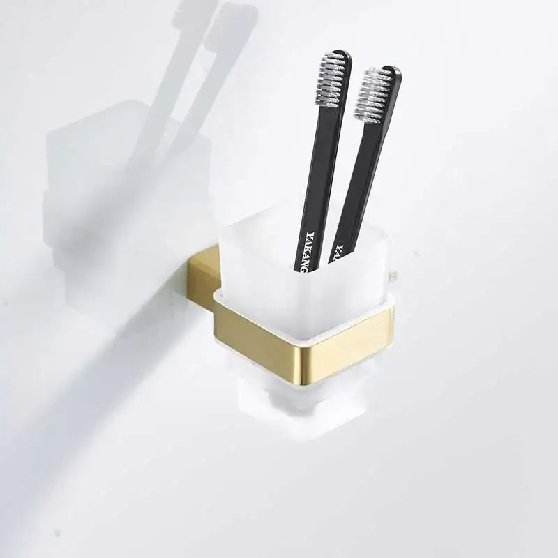 Modern brushed gold and white stainless steel toothbrush holder with two black toothbrushes decorbites brushed gold decor