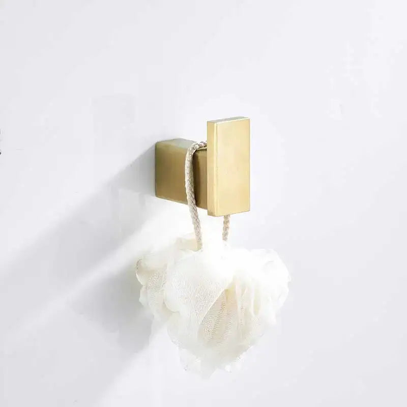 Brushed gold stainless steel rectangular wall hook holding white textured loofah from decorbites brushed gold set