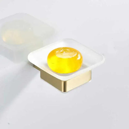 Brushed gold rectangular soap dish with translucent white stainless steel base holding yellow soap bar decorbites brushed gold