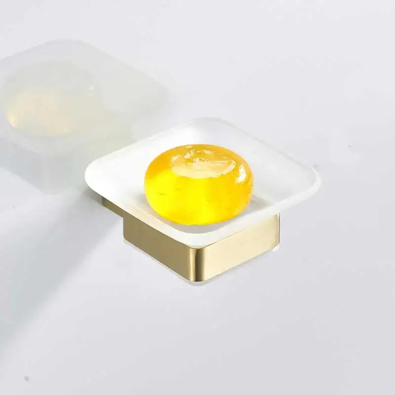 Brushed gold rectangular soap dish with translucent white stainless steel base holding yellow soap bar decorbites brushed gold