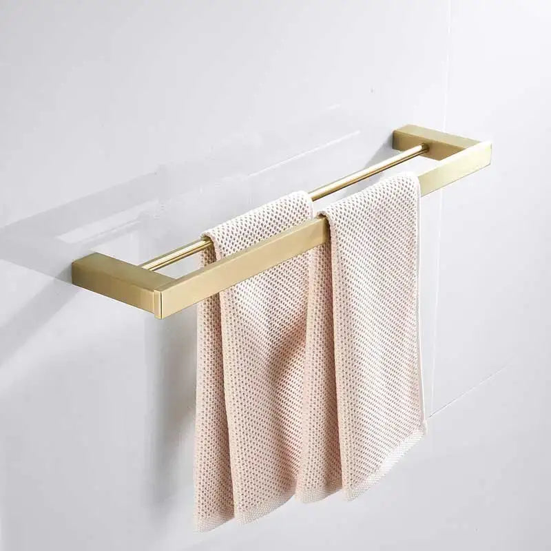 Brushed gold stainless steel double towel rack with modern design holding two light pink textured towels decorbites brushed gold