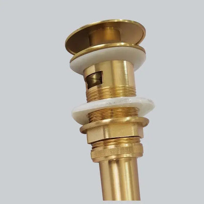 Brushed gold basin sink drain with overflow featuring gold-toned brass and white ceramic washers for decorbites brushed gold decor